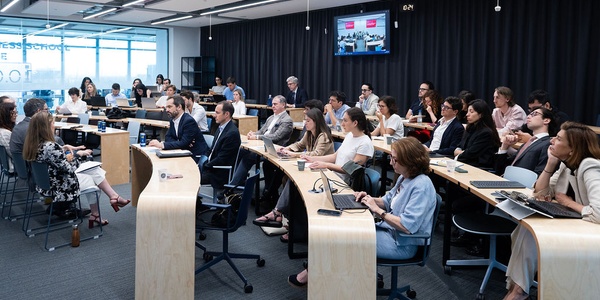 A diverse group of people engaged in a meeting or discussion in a modern conference room.
