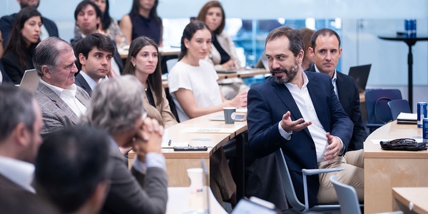 A group of people engaged in a discussion during a conference.