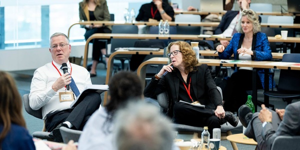 A group of people engaged in a discussion during a conference or seminar.