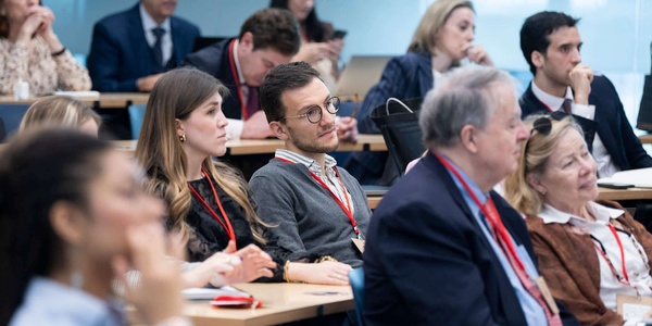 A group of people listening intently at a conference or seminar.