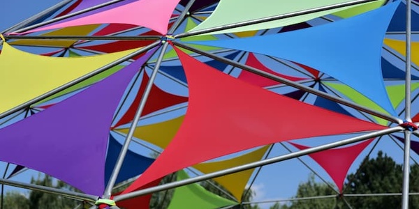 Colorful geometric canopy constructed with multicolored triangular fabrics and a metal frame
