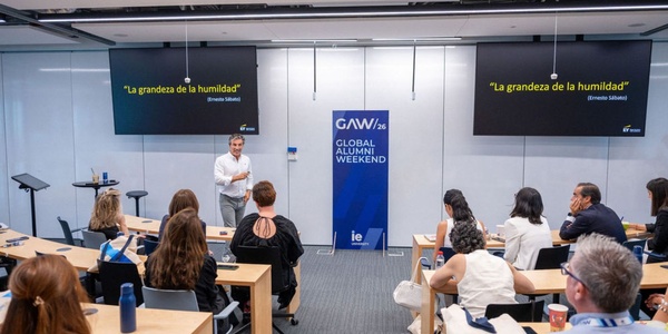 A speaker presents in front of an audience during the Global Alumni Weekend event.