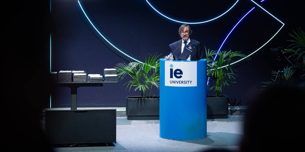 A speaker presents at an event held by IE University.