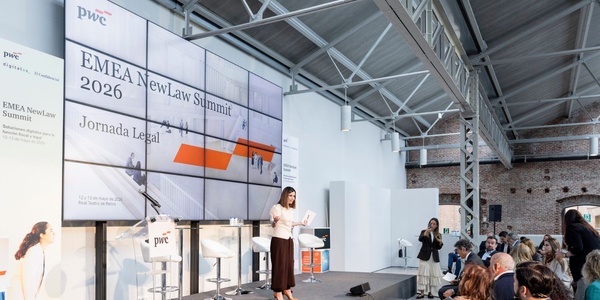 A speaker presents at the EMEA NewLaw Summit 2026 in a modern venue.