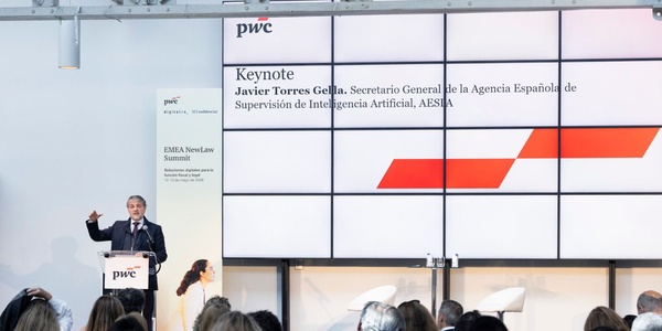 A keynote speaker presents at an event, discussing artificial intelligence oversight.