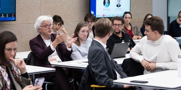 A group of people engaged in a discussion during a meeting.