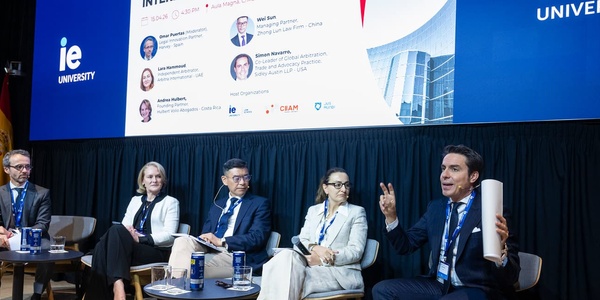 A panel discussion featuring multiple speakers at an university event.