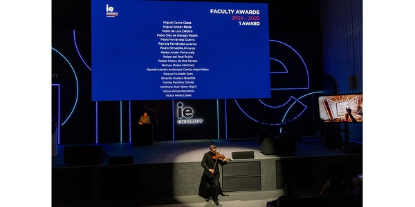 A performer playing a string instrument on stage during an awards ceremony.