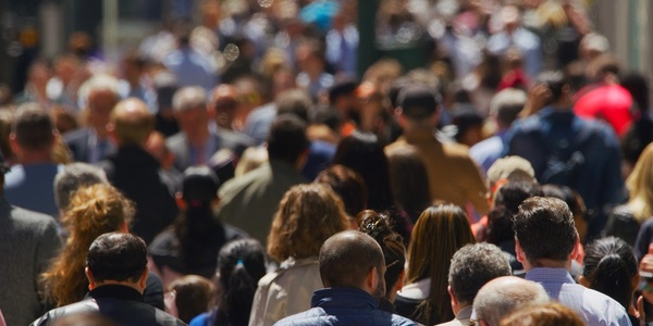 Many people walking across the street
