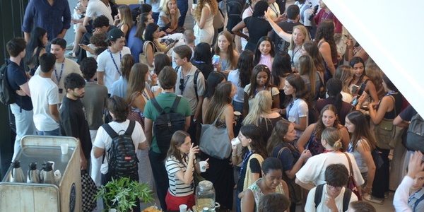 A lively gathering of many people socializing in a communal space.