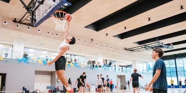 A basketball player is dunking the ball during practice.