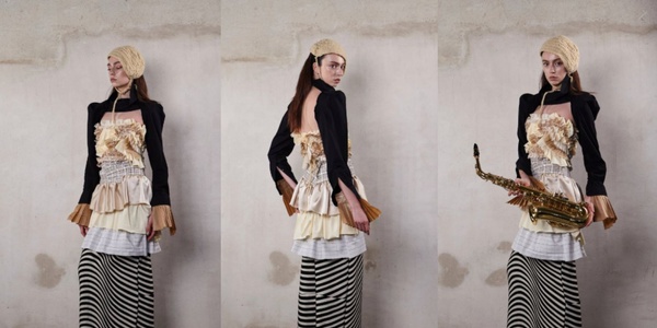 A stylish model showcases a unique fashion ensemble with a saxophone.