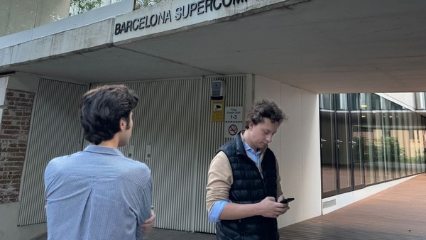A group of people standing outside the Barcelona Supercomputing Center entrance.