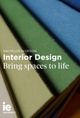 A promotional image featuring a stack of colorful books with text superimposed discussing a Bachelor in Design, focusing on Interior Design at IE University.