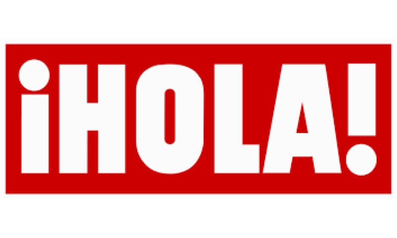 The image displays the word '¡HOLA!' in white letters on a red background.