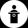 A simple silhouette of a person at a podium.
