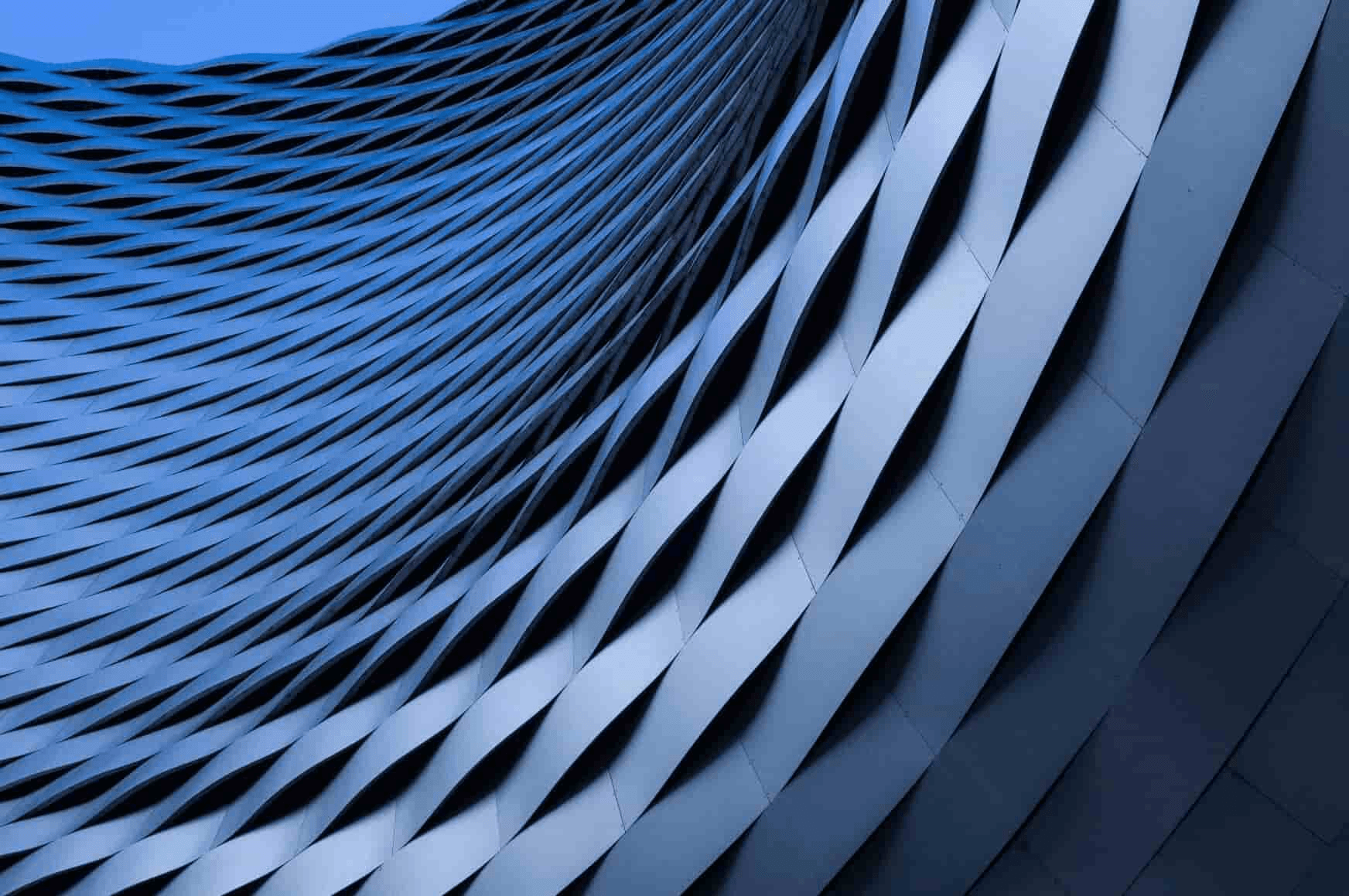 Abstract view of a modern architectural facade with repeating geometric patterns.