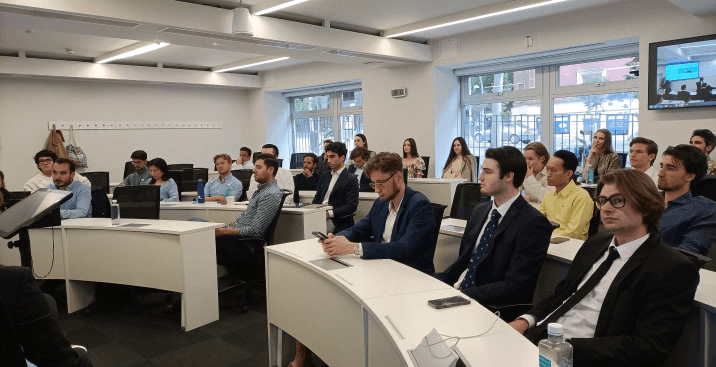 A group of professionals attending a lecture in a modern classroom setting.