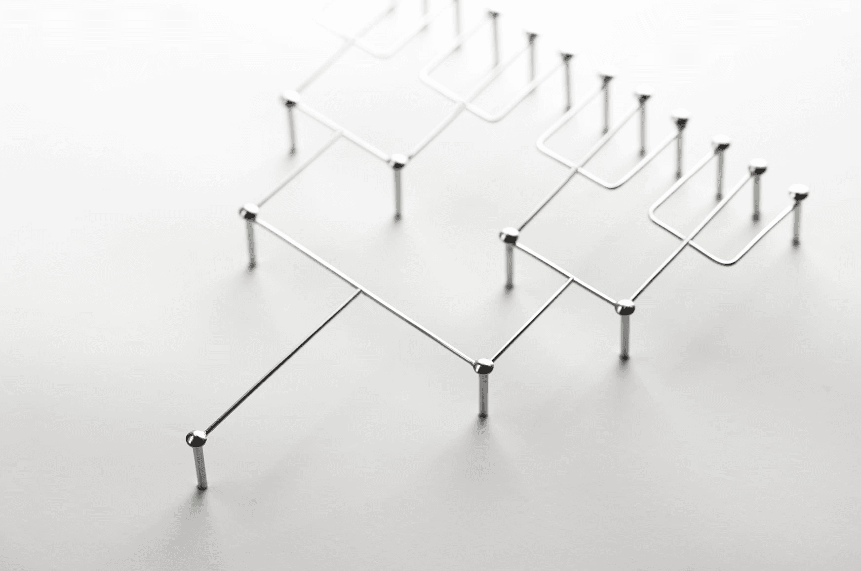A minimalist metal structure composed of interconnected lines and rods.