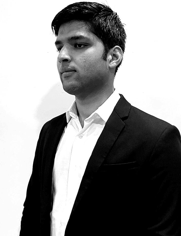 A black and white photo of a young man in a suit looking to the side.