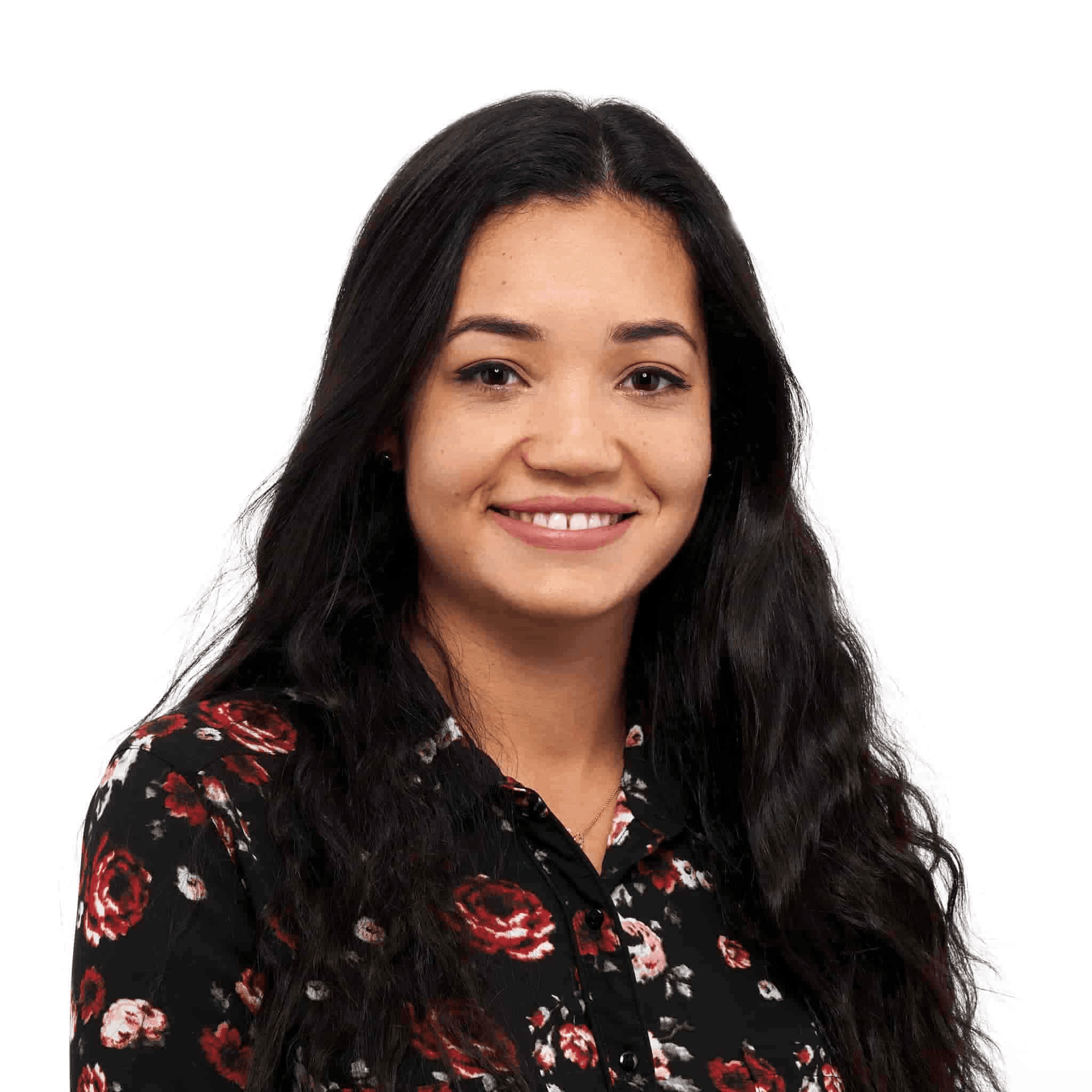 A smiling woman with long dark hair, wearing a floral print black blouse against a plain white background.